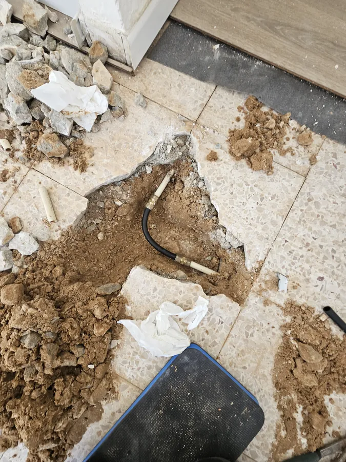 החלפת קו מים - צינור חדש מונח בתעלה שנפתחה בריצוף