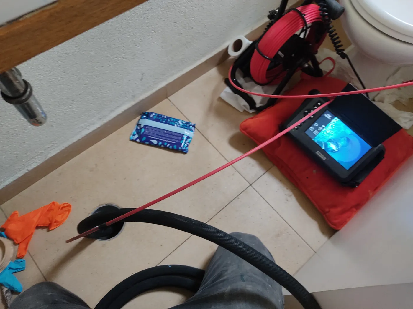 מצלמת צנרת נכנסת דרך פתח הניקוז ברצפה